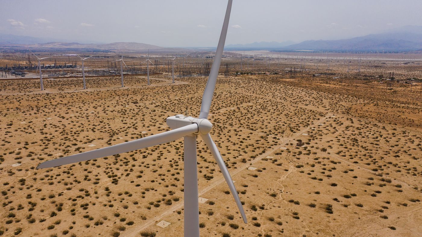 Aerial view of wind turbines on arid ground