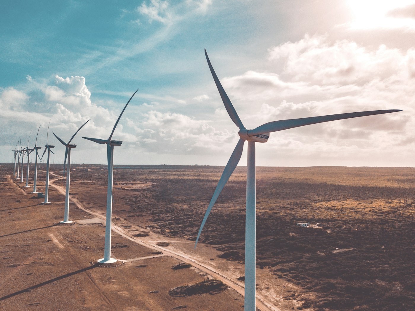Row of wind turbines in a desert landscape